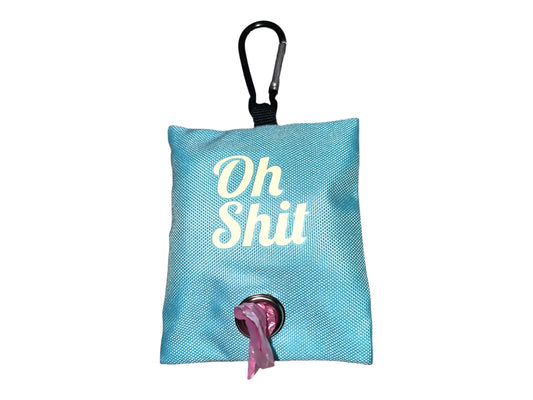 A blue fabric poop bag holder with the text 'OH SHIT' printed on it, featuring a black snap closure and a roll of poop bags attached.